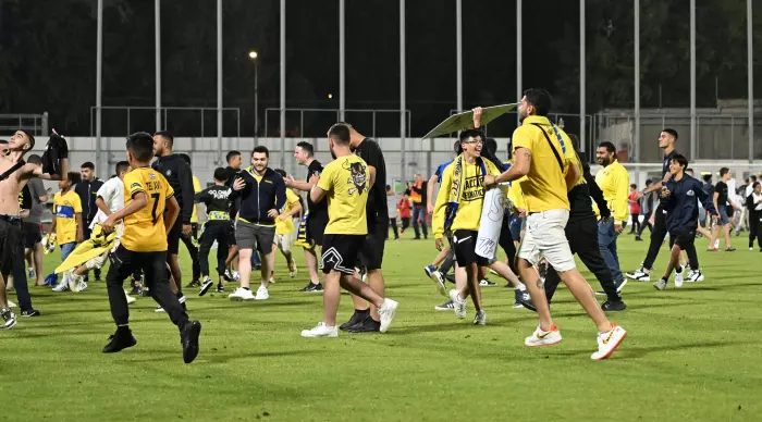 Maccabi Tel Aviv fans break into the grass
